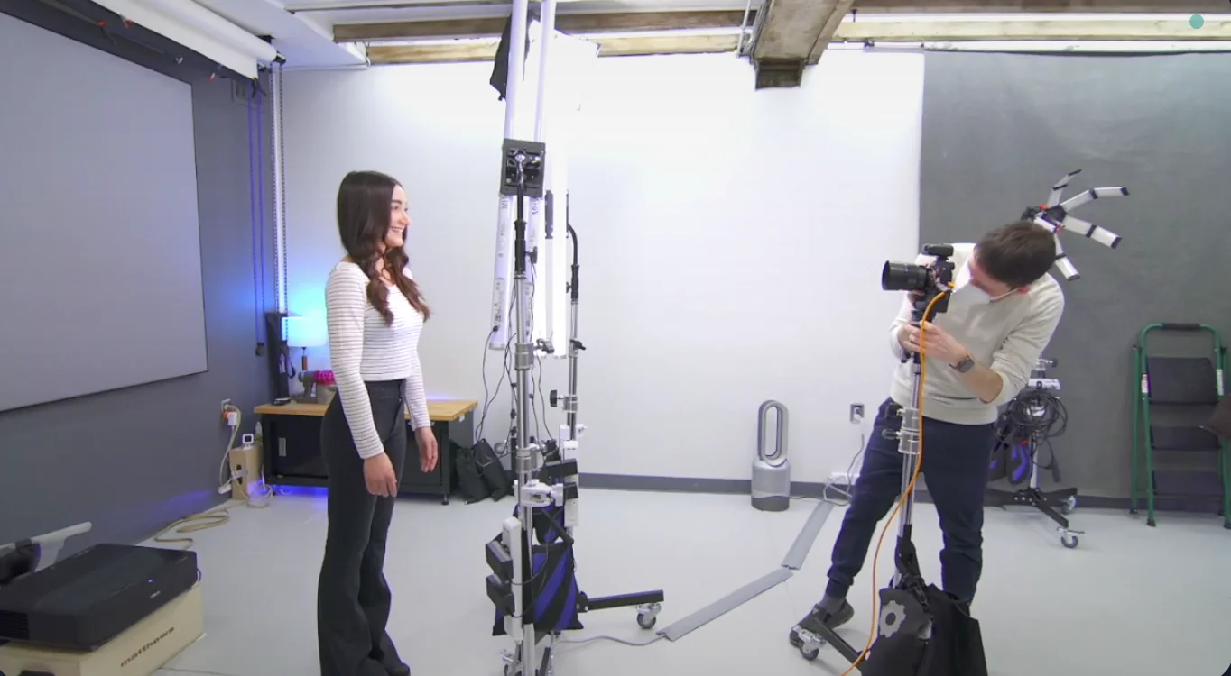 Professional photographer working with client during headshot session showing the guided process